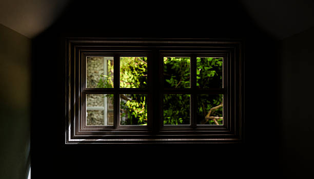 istock Sunlight illuminating a window in a dark room 2214272448
