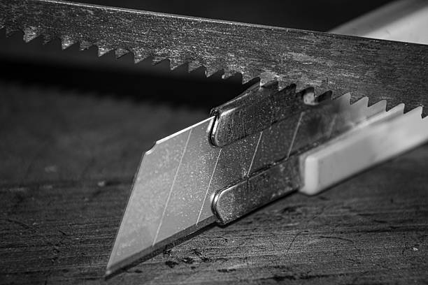 istock Exacto and saw blade left on the workbench 2214272508