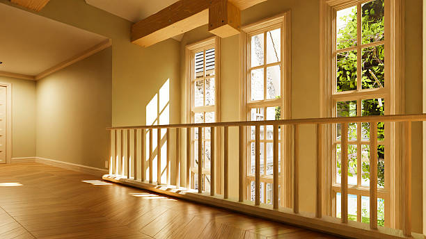 istock Sunlight illuminating empty hallway with wooden railing and parquet 2214272511