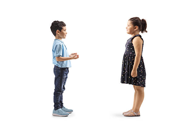 istock Full length profile shot of two kids standing and talking 2214272802