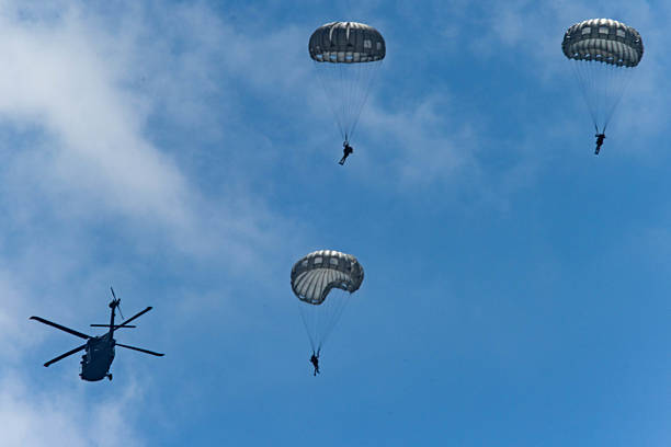 istock Army Paratroopers exit a helicopter in mid-air during a training exercise, highlighting their tactical airborne maneuvers. 2214273596