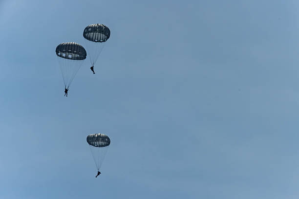 istock Army Paratroopers exit a helicopter in mid-air during a training exercise, highlighting their tactical airborne maneuvers. 2214273598