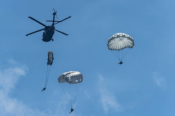 istock Army Paratroopers exit a helicopter in mid-air during a training exercise, highlighting their tactical airborne maneuvers. 2214273605
