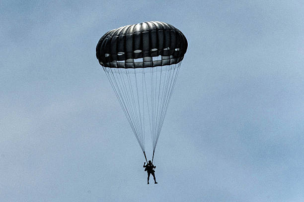 istock Army Paratroopers exit a helicopter in mid-air during a training exercise, highlighting their tactical airborne maneuvers. 2214273608