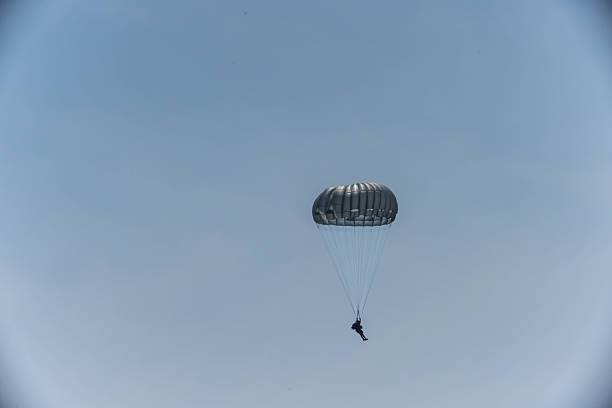 istock Army Paratroopers exit a helicopter in mid-air during a training exercise, highlighting their tactical airborne maneuvers. 2214273647