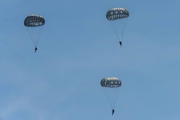 istock Army Paratroopers exit a helicopter in mid-air during a training exercise, highlighting their tactical airborne maneuvers. 2214273689