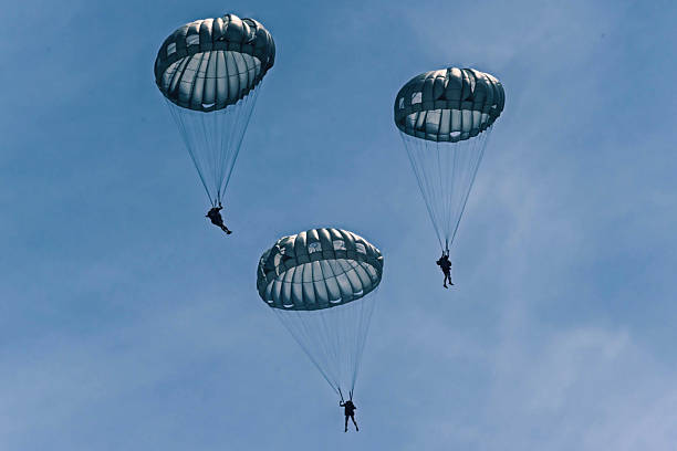 istock Army Paratroopers exit a helicopter in mid-air during a training exercise, highlighting their tactical airborne maneuvers. 2214273700