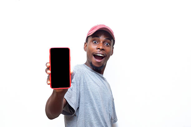 istock Excited Young Man Presents Blank Smartphone Screen on White Background 2214274786