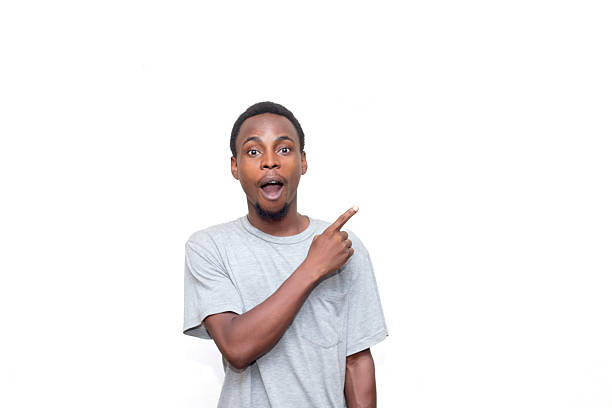 istock Surprised Individual Pointing Up With Excited Expression Against White Background 2214274831