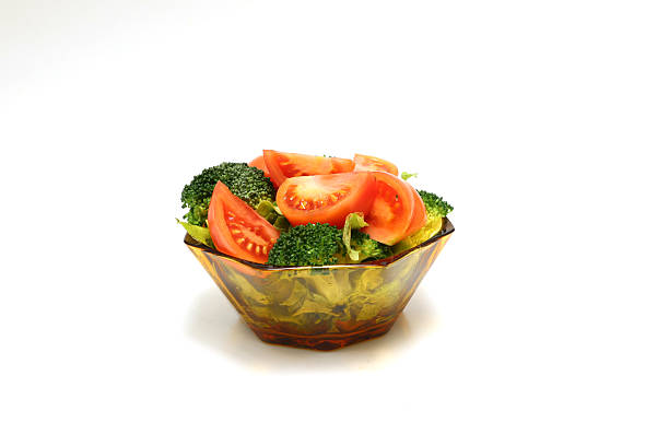 Fresh vegetable salad in a glass crockery isolated on a white background.