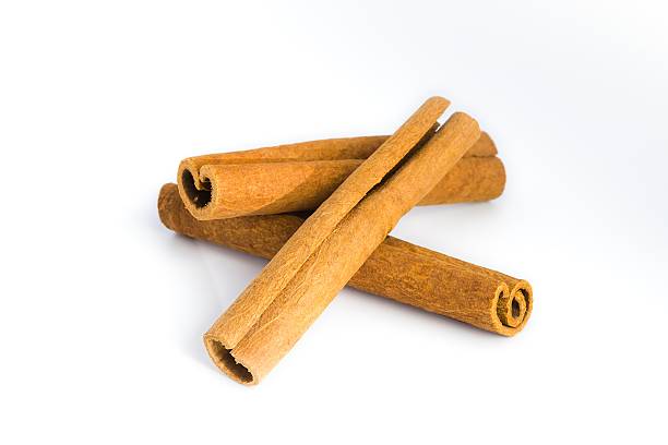 istock Assorted cinnamon bark pieces arranged on white, focusing on their fibrous texture and earthy hues. 2214277977
