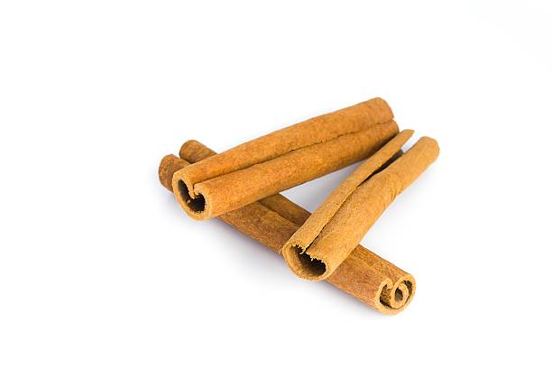 istock Isolated cinnamon bark pieces on white, emphasizing their rugged surfaces and deep brown shades. 2214277984