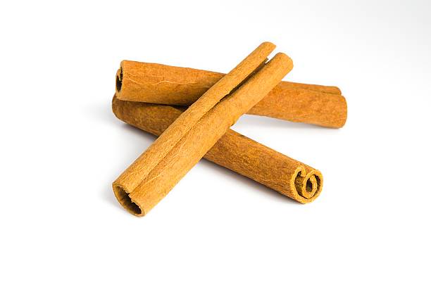 istock Assorted dried cinnamon bark pieces on white, focusing on their natural curves and coarse surfaces. 2214277990