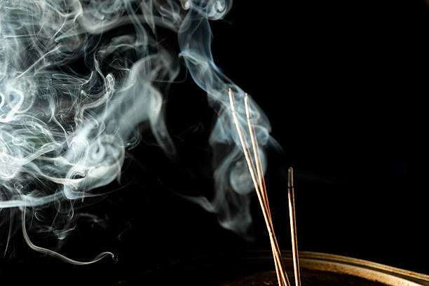 istock Dancing incense smoke with light in the dark. 2214279773