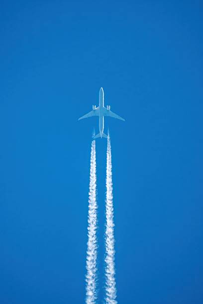 istock A jet is flying through the sky with white smoke trailing it 2214282063