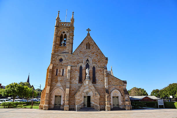 View of St Michael Catholic Cathedral, a large sandstone Victorian Academic Gothic building consecrated in 1925 in the city of Wagga Wagga, New South Wales, Australia