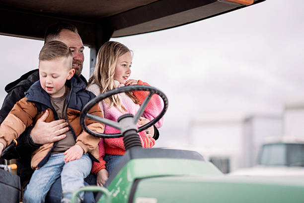 istock Farmer with his kids at the farm 2214285903