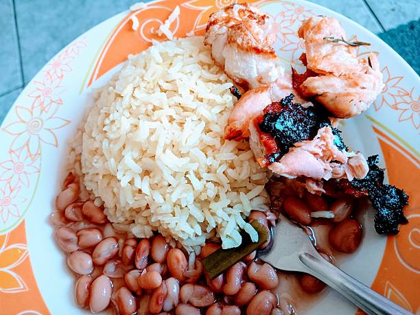 Traditional turkish baked beans, rice and salad on wooden table