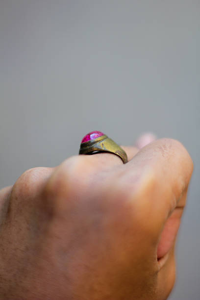 istock pink gemstone ring worn on the middle finger 2214295150