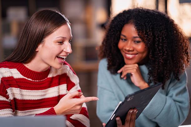 istock Two women with teamwork Laptop and research for articles, collaborations, and schedule evening, after-hours meetings. 2214298059