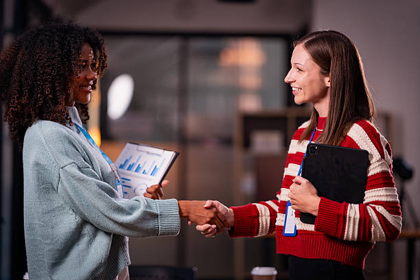 istock Two women's hands shaking hands symbolizes effective negotiation, making an agreement, greeting business partners or mutual respect in the workplace. 2214298084
