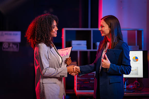 Two women's hands shaking hands symbolizes effective negotiation, making an agreement, greeting business partners or mutual respect in the workplace.