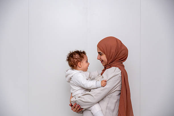 istock Lovely Moment Between a Smiling Mother and Her Baby in a Warm Setting 2214300908