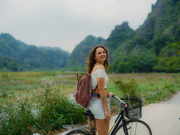istock Woman exploring Ninh Binh on bicycle 2214302699