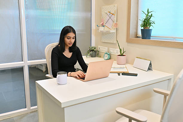 istock Focused female Entrepreneur working on a laptop in Modern Office 2214308542