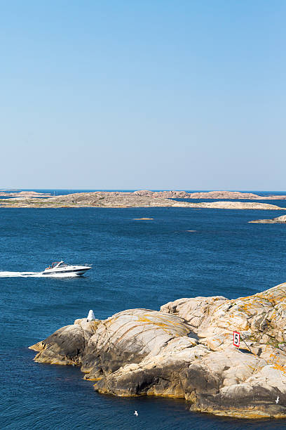 istock Motor boat in the archipelago with cliffs 2214315695