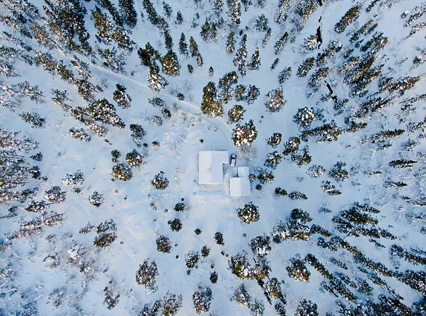 istock Top-down aerial view of a snow-covered cabin 2214316057
