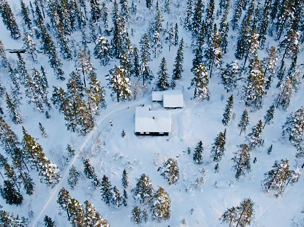 istock Top-down aerial view of a snow-covered cabin 2214316067