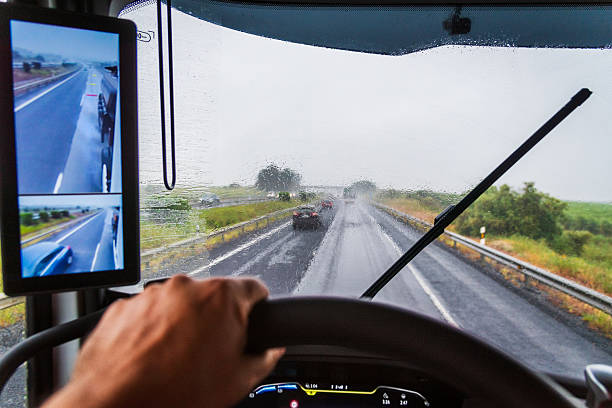 istock Truck windshield completely soaked by heavy rain, seen from inside the vehicle while driving on a highway 2214317962