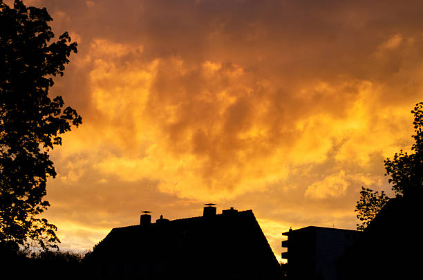 Yellow sky with cumulus clouds in the evening at sunset in Germany.