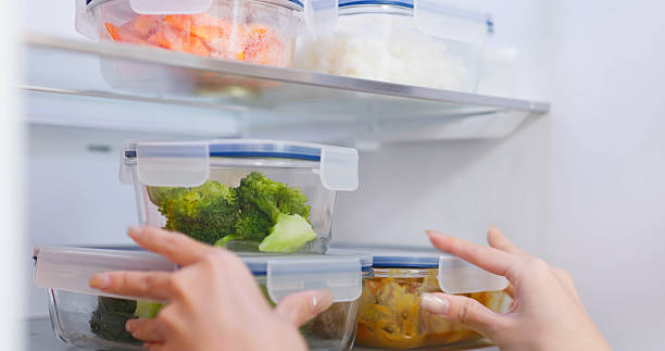 istock Asian Woman Storing Food fridge 2214319521