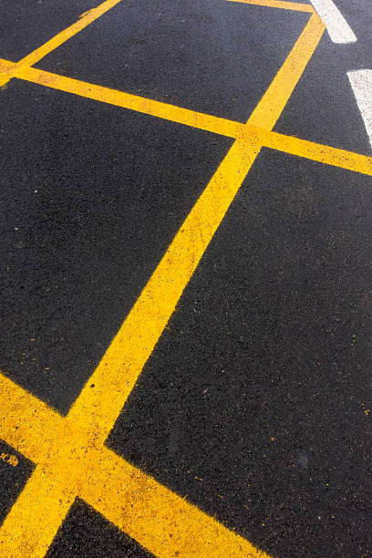 istock yellow line on black asphalt 2214321283