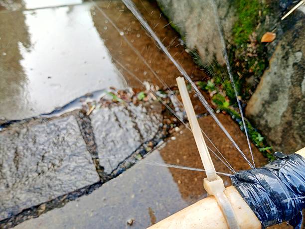 Fresh water flows from PVC pipes in the open air.