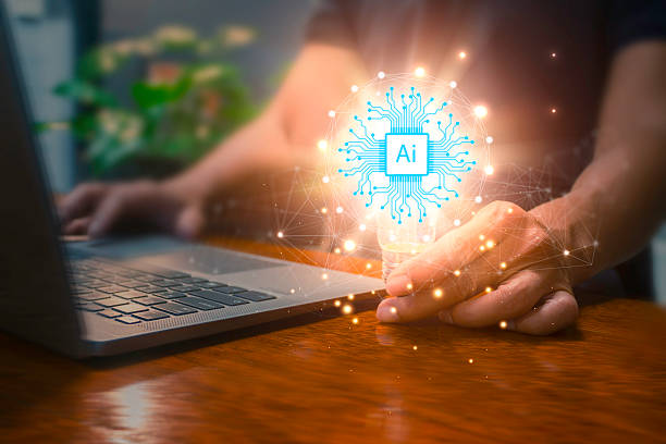 istock Man using laptop and  holding illuminated lightbulb idea innovation and inspiration with glowing virtual smart intelligent creativity. 2214324780