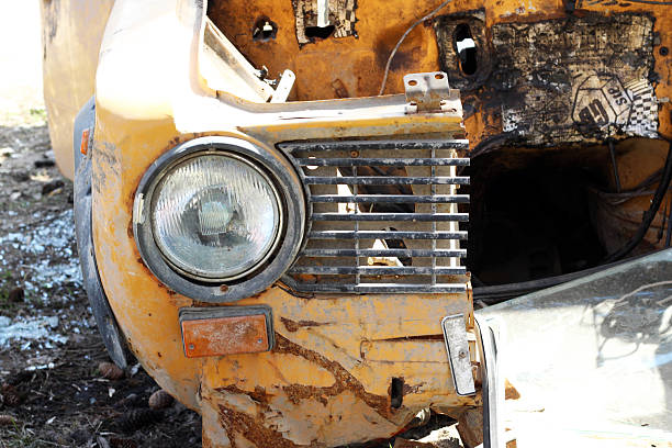 A wrecked yellow Russian car in the forest. Retro.