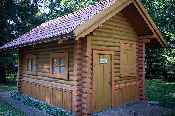 istock A small log cabin with a red roof and yellow trim 2214326590