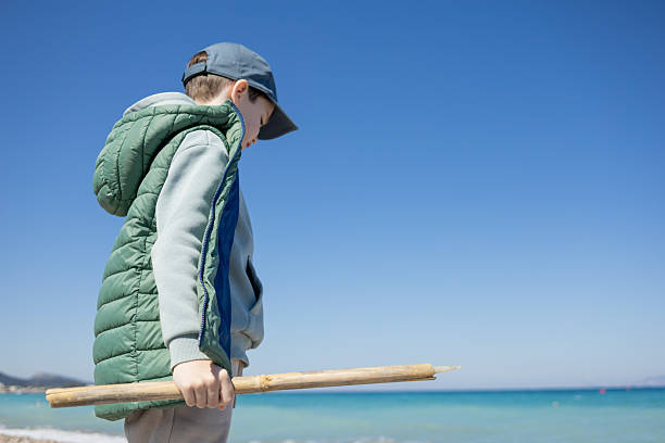 A 7-year old boy walks along the Mediterranean coast