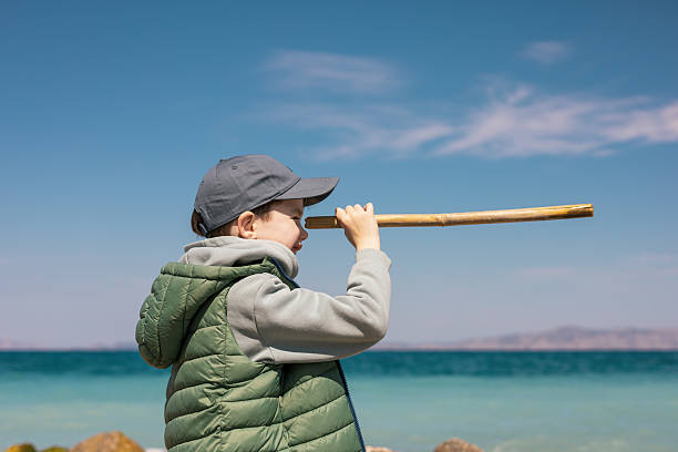 A 7-year old boy walks along the Mediterranean coast