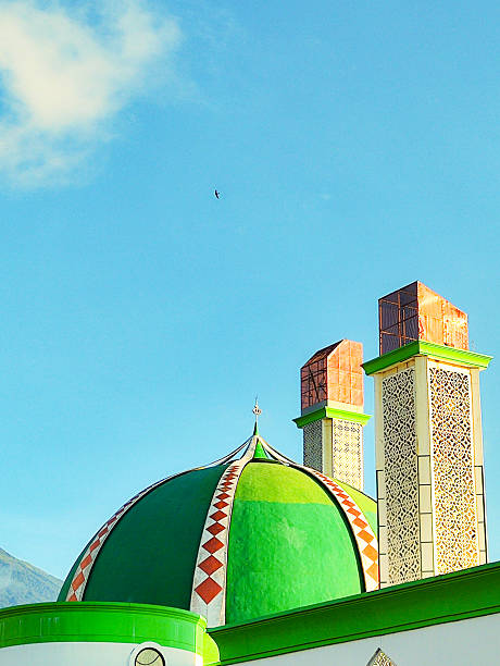istock green mosque tower and dome with blue sky background 2214329050