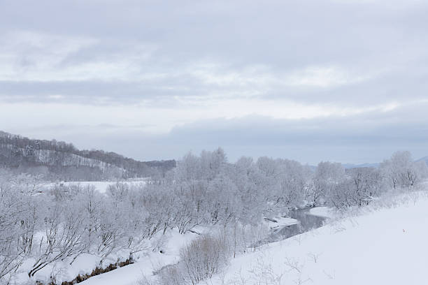 istock River flowing through white frozen winter landscape 2214331114