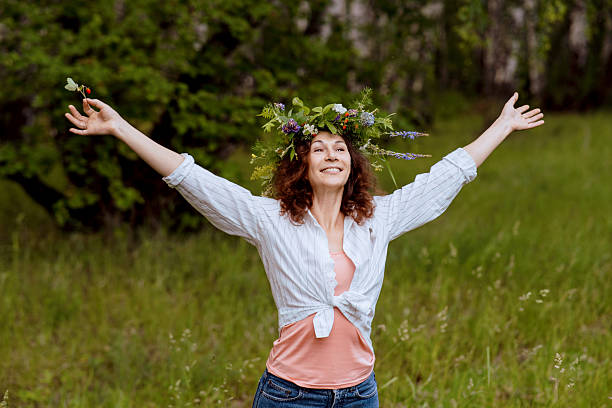 istock Cheerful middle-aged woman outdoors reconnecting with nature 2214334082