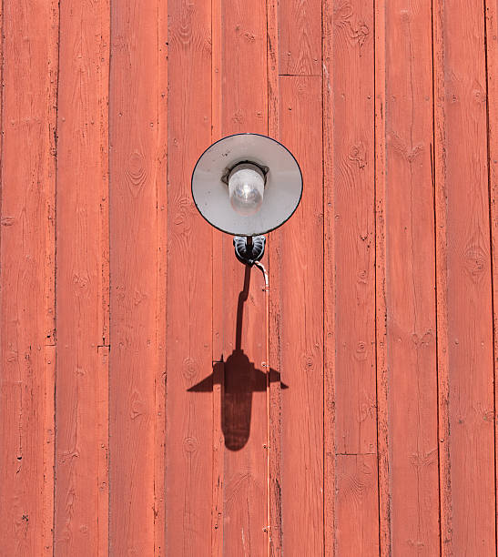 istock Vintage Wall-Mounted Lamp on Rustic Red Wooden Wall 2214334146