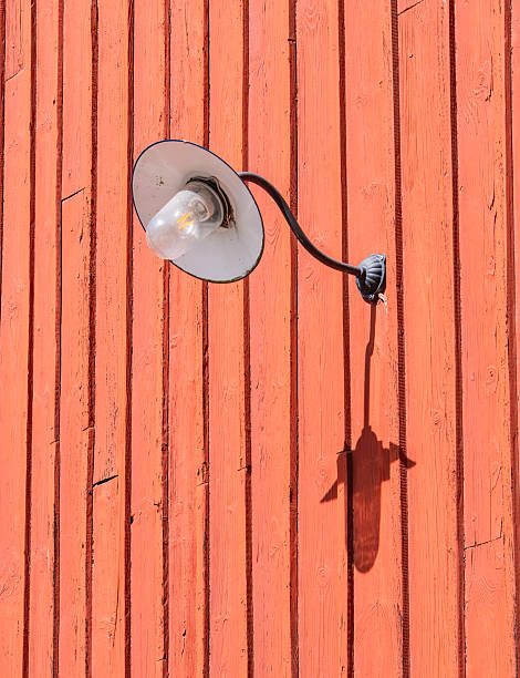 istock Vintage Wall-Mounted Light on Orange Wooden Wall 2214334152