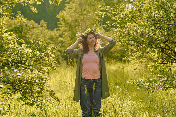 Outdoor meditation retreat in wild meadow: woman embracing presence and simplicity. Scene of wellness, energy and grounded soul care