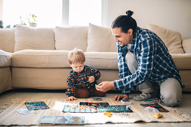 istock Father showing his boy a game he has made. 2214336497