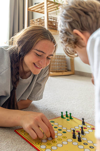 istock Girl playing board game with younger brother. Board game. Educational board game. 2214338543